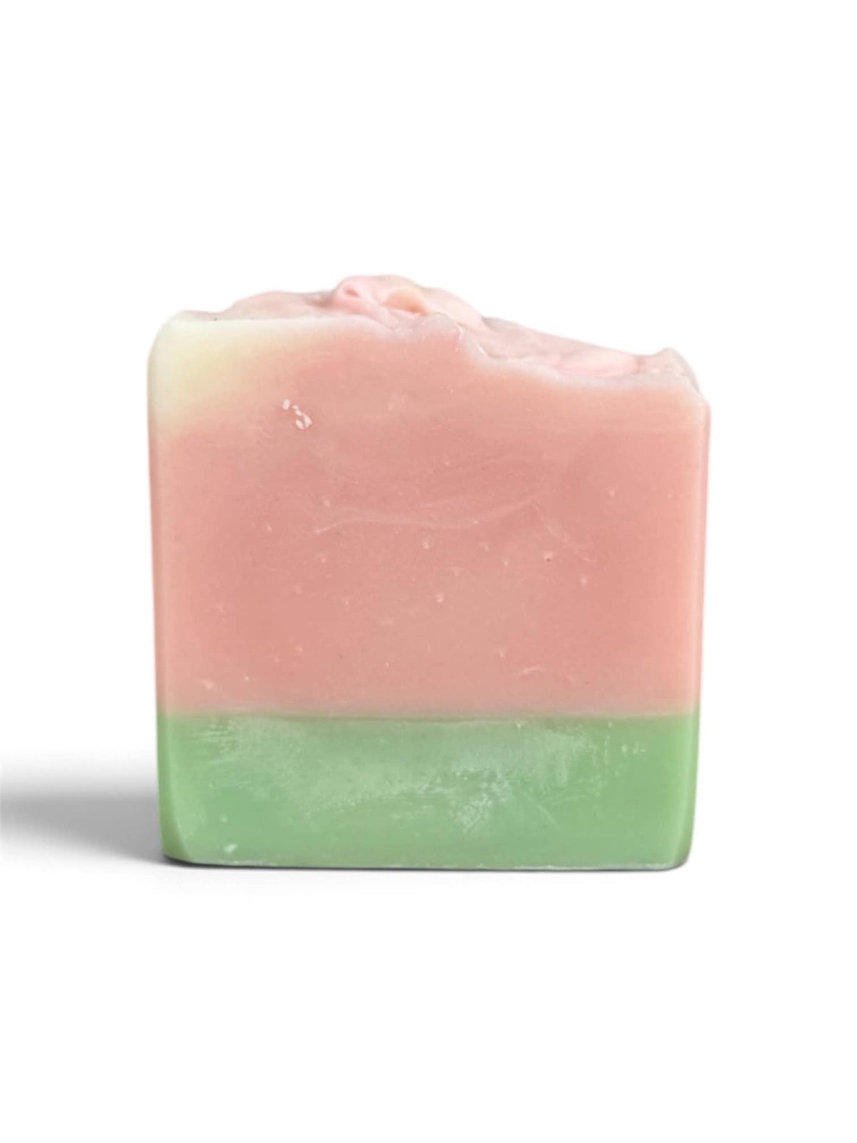 A rectangular bar of handmade soap with a two-tone design, featuring a light pink top half and a light green bottom half, set against a plain white background.