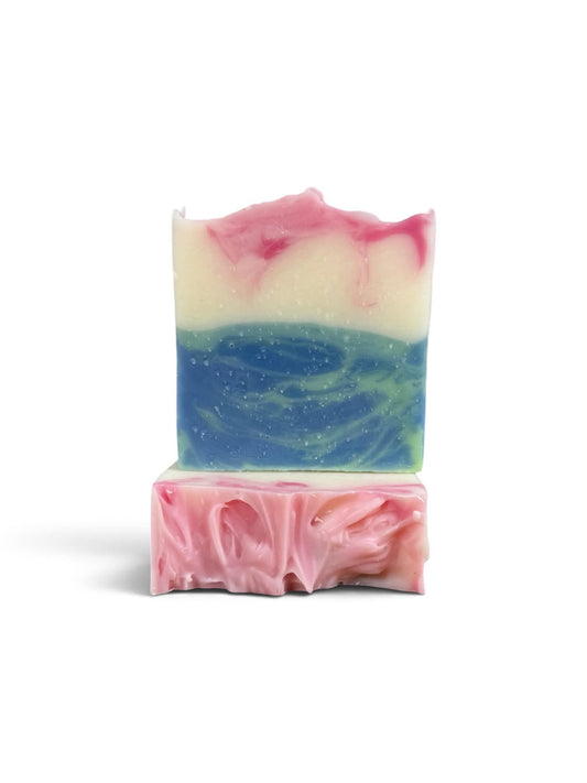 A handmade rectangular bar of soap with a swirled pink, white, and blue design, displayed on a clean white background.