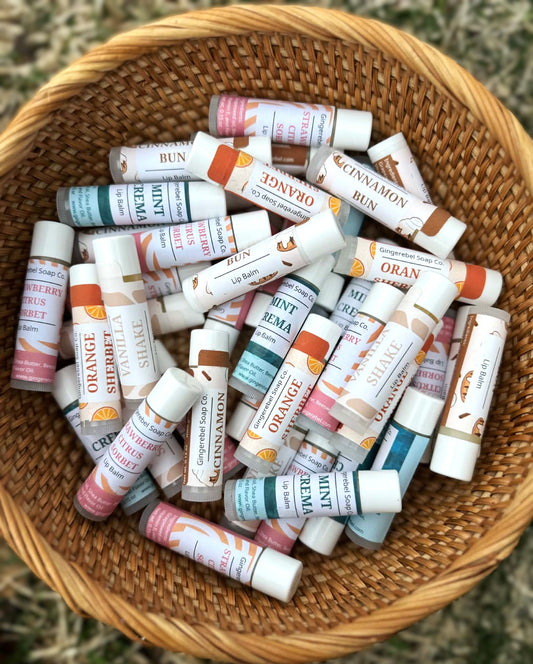 Basket filled with various lip balm tubes with different flavors and colors.