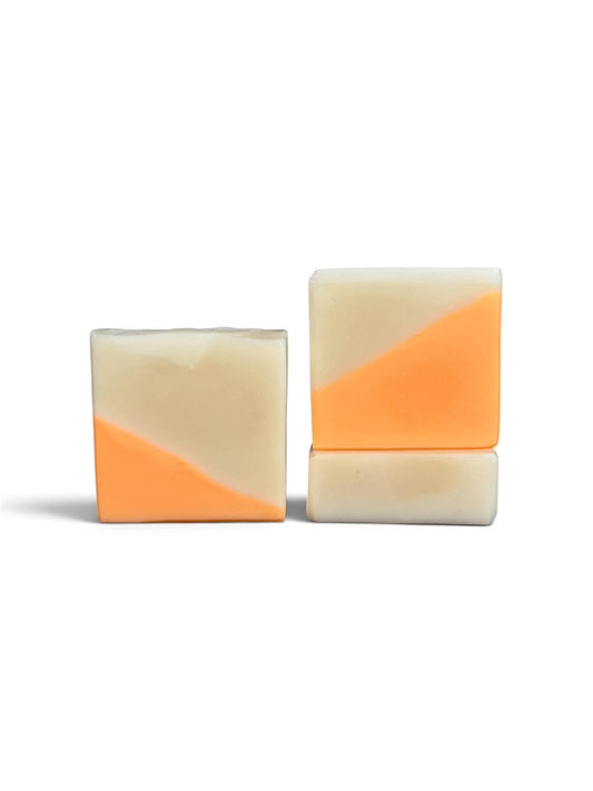 3 bars of soap, with a diagonal split design of orange and cream.