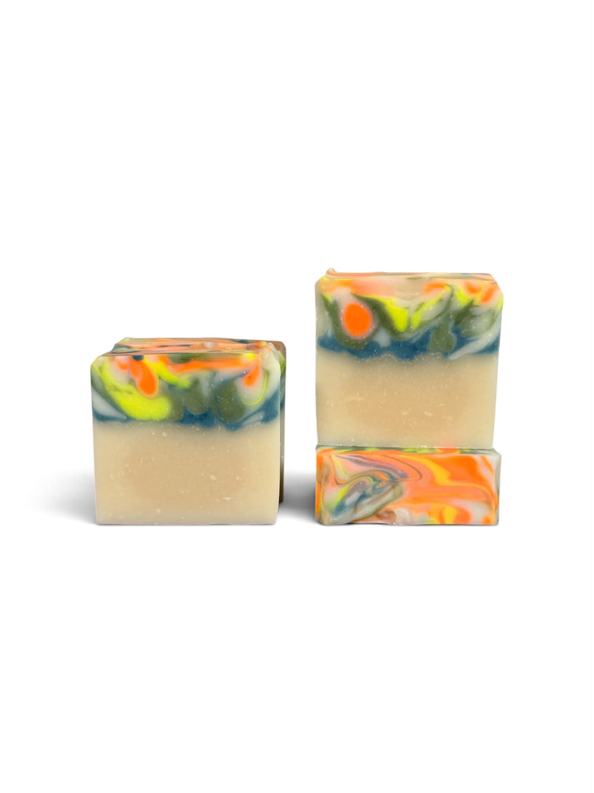 Three rectangular handmade soap bars with a creamy beige base and colorful marbled swirls of orange, yellow, green, and blue on a white background.
