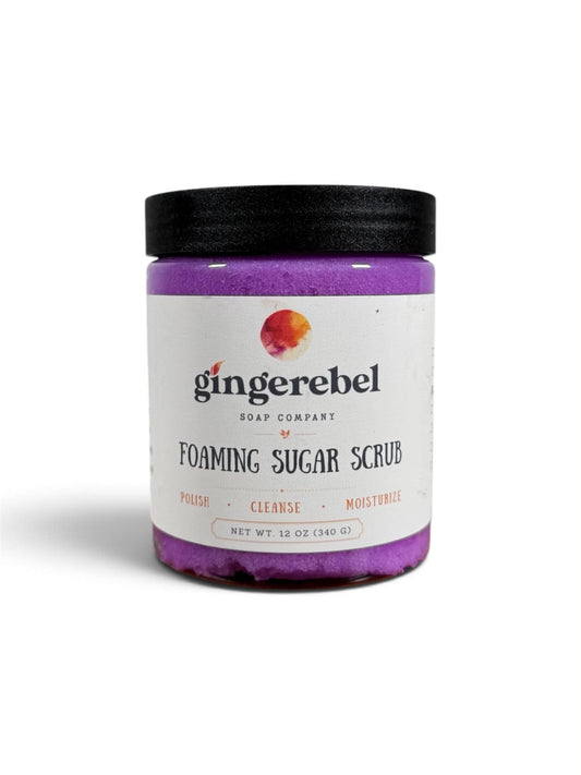 A jar of purple sugar scrub with a white label. 