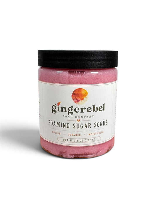 A jar of pink watermelon sugar scrub, with a white label on a white background. 