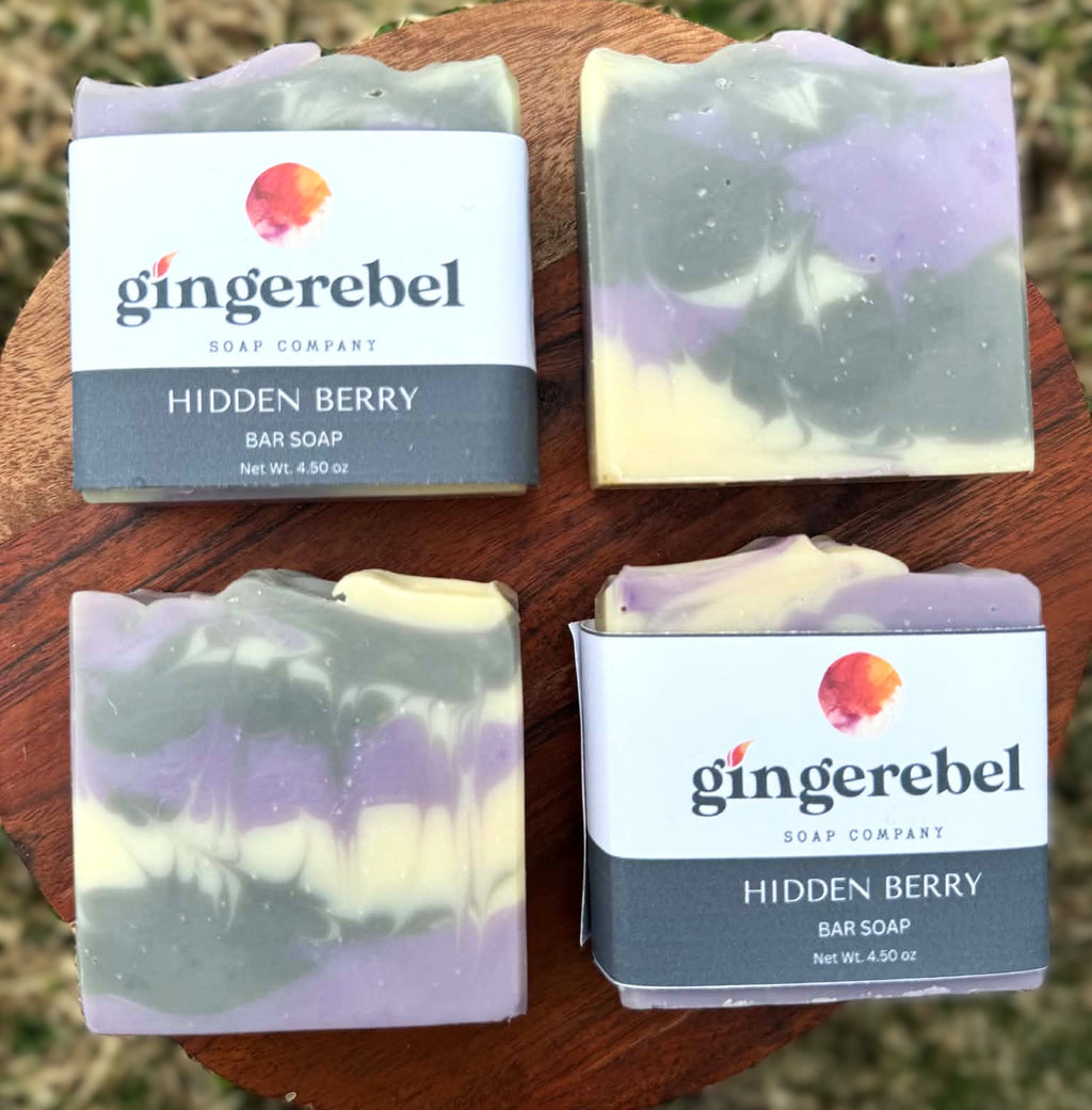 Four bars of 'Hidden Berry' soap from Gingerebel Soap Company on a wooden surface.