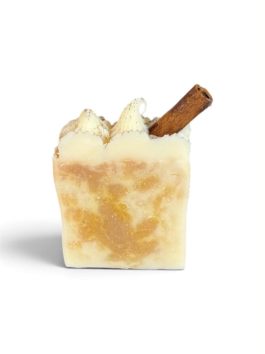 one square soap with orange and cream swirls with a cinnamon stick on top