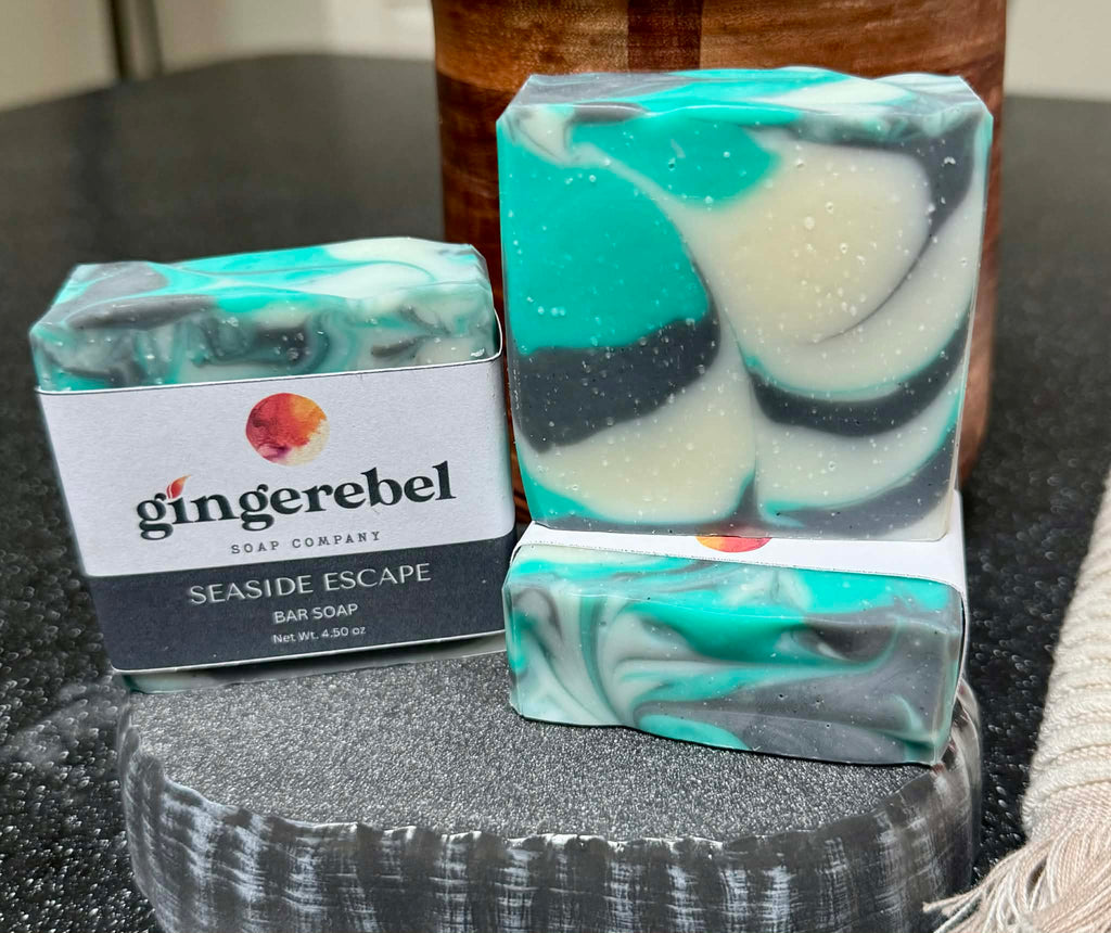 Bar of soap with a 'Gingerebel Soap Company' packaging on a dark surface