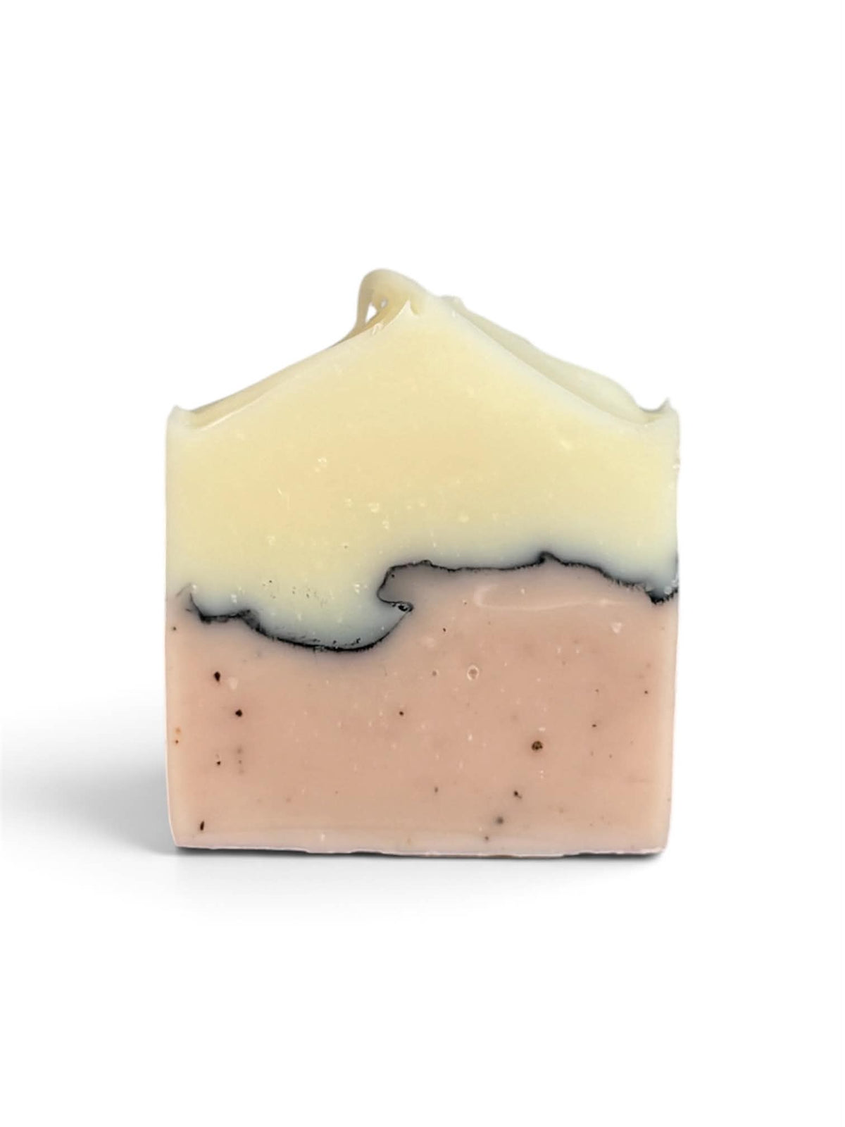 A rectangular bar of handmade soap with a two-tone design, featuring a pale cream-colored top layer and a light pink bottom layer with small dark specks, set against a plain white background.