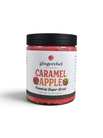 A jar of Gingerebel Caramel Apple Foaming Sugar Scrub with a black lid and white label, set against a plain white background.