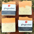 Two bars of Citrus Bergamot soap from Gingerebel Soap Company on a wooden surface.