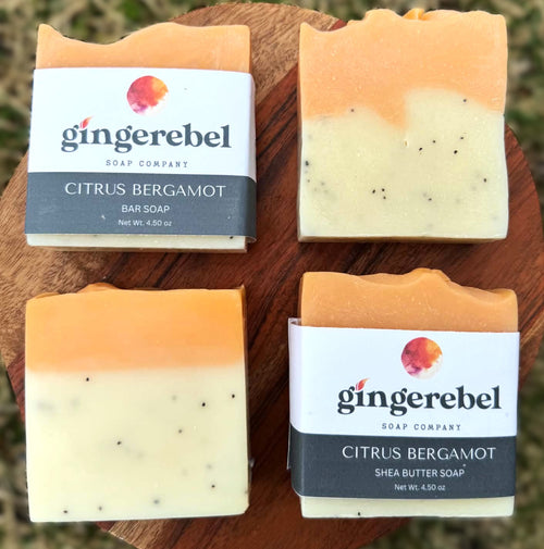 Two bars of Citrus Bergamot soap from Gingerebel Soap Company on a wooden surface.