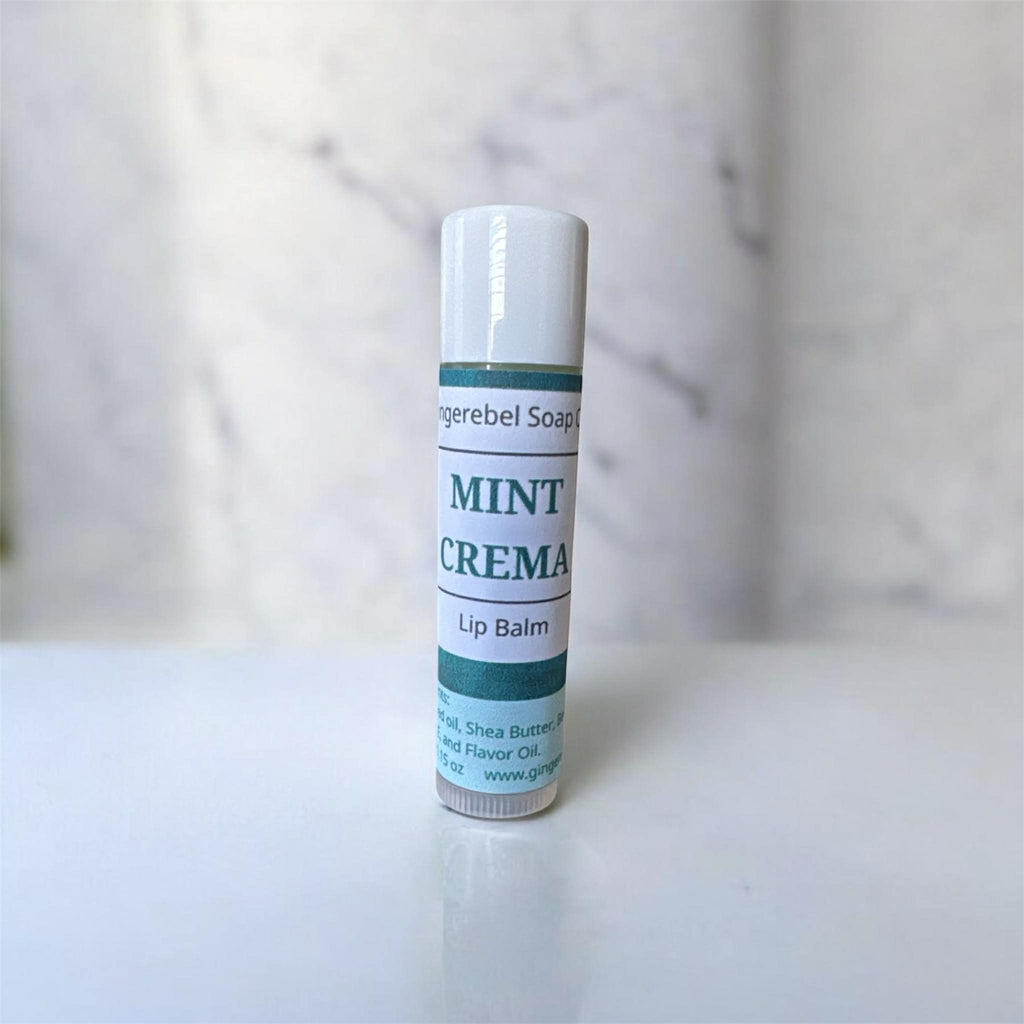Lip balm tube labeled 'Mint Crema' on a marble background