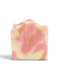 A single rectangular bar of handmade soap with a swirled pattern of pink, cream, and light orange, featuring tiny embedded glitter, set against a plain white background.