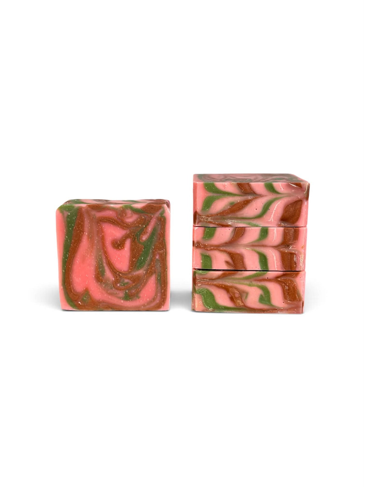3 bar soaps stacked showing the top pink, green, and brown swirls, and 1 bar soap showing the swirls from the front. 