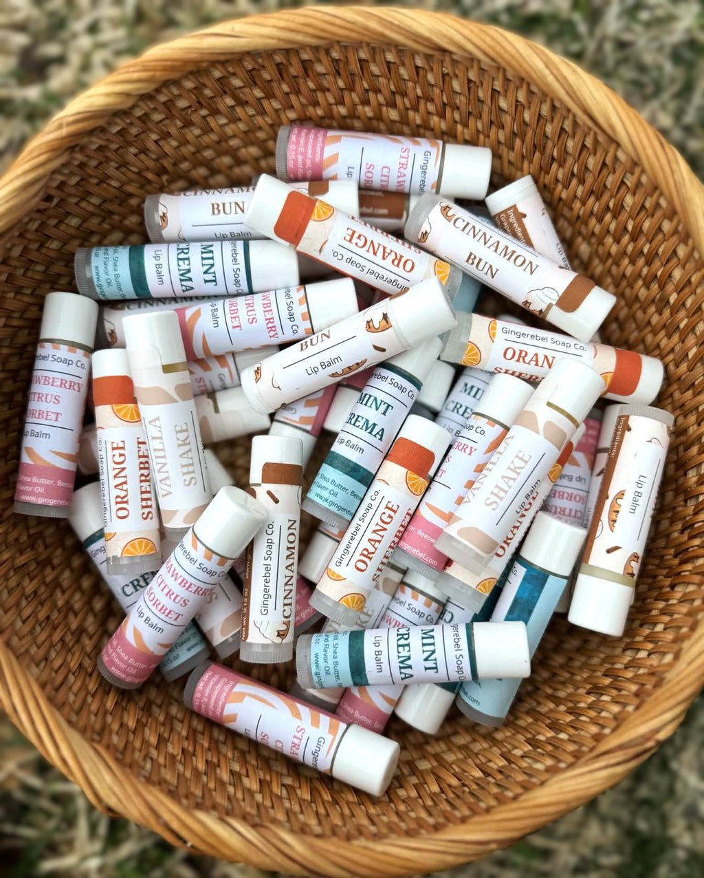 Basket filled with various lip balm tubes with different flavors and colors.