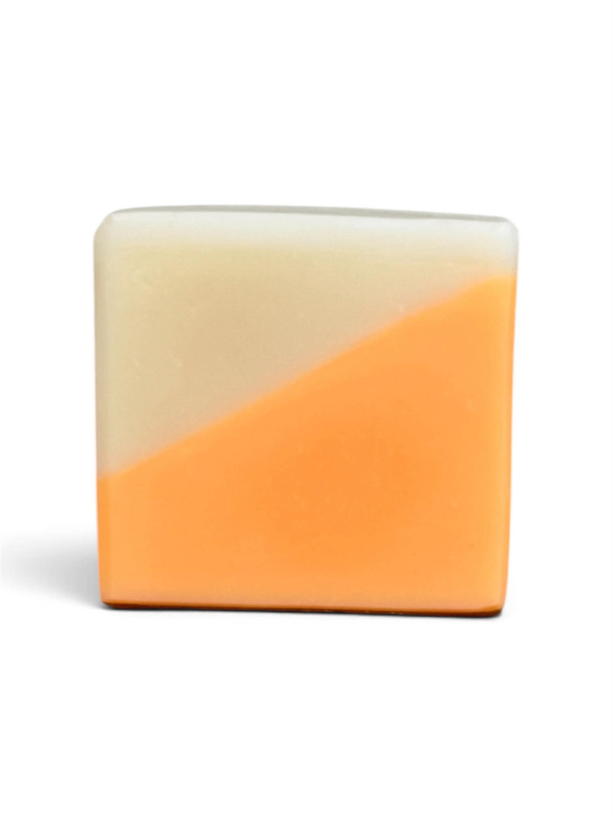 A square bar of soap with a diagonal split design, featuring a warm cream-colored top half and a vibrant orange bottom half, set against a plain white background.