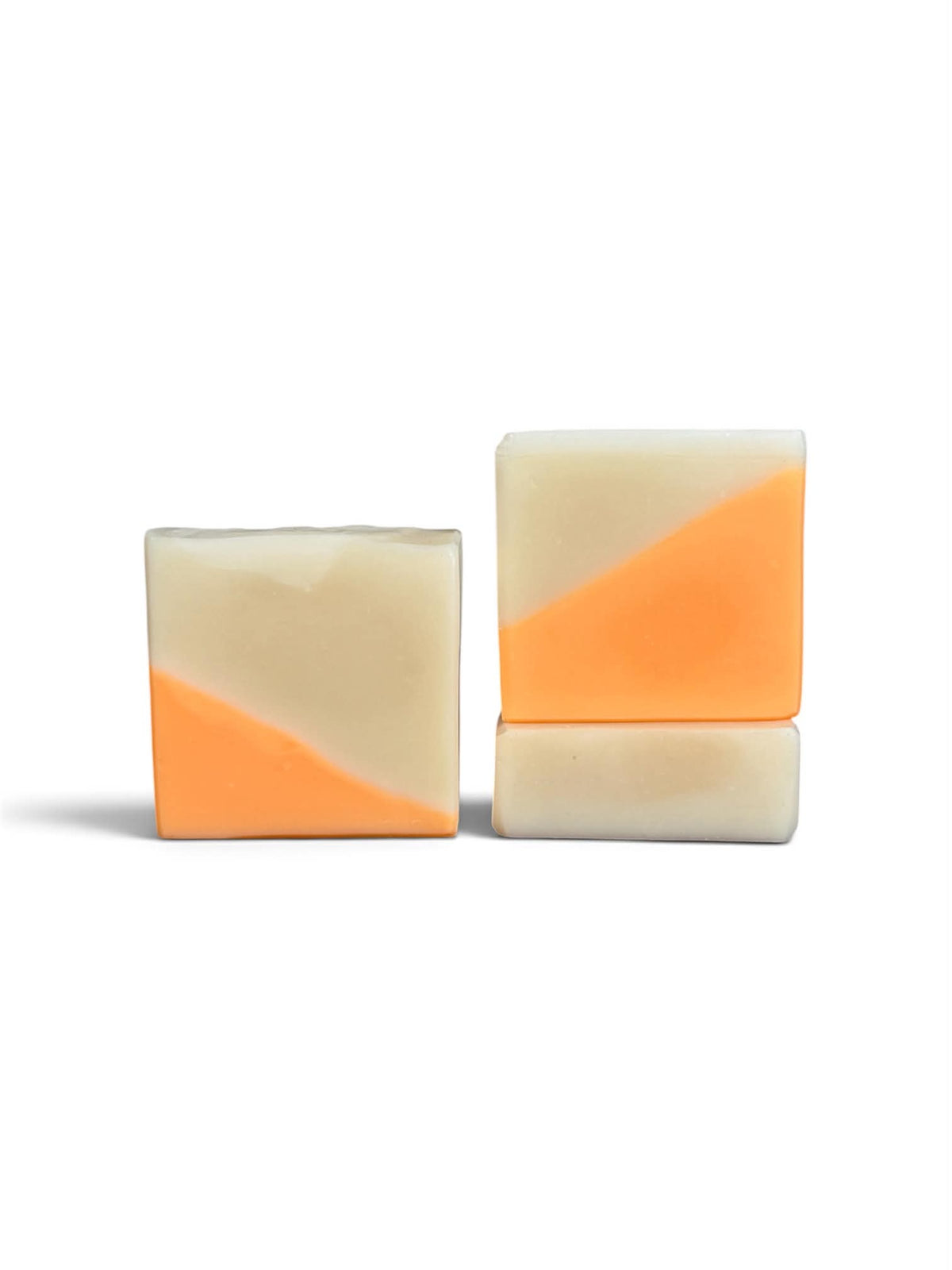3 bars of soap, with a diagonal split design of orange and cream.